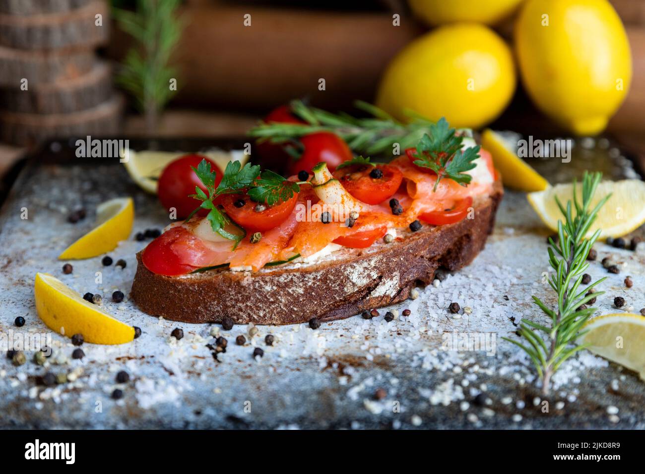 Salted salmon open sandwich with tomatoes, cream cheese, cucumber
