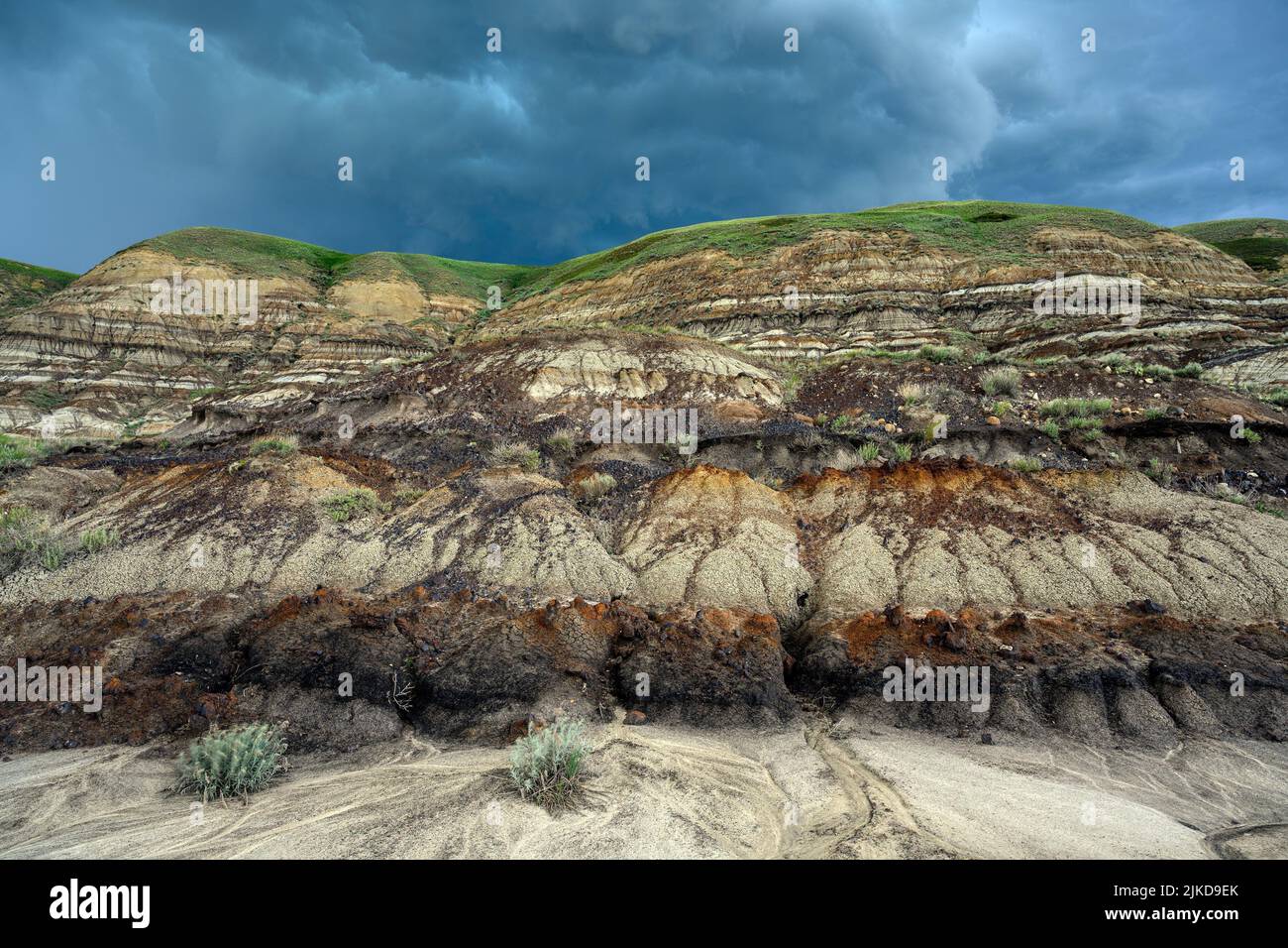 Stormy clouds over the landscape of the Canadian Badlands of Drumheller, the dinosaur capital of the world in Red Deer River Valley, Alberta, Canada. Stock Photo