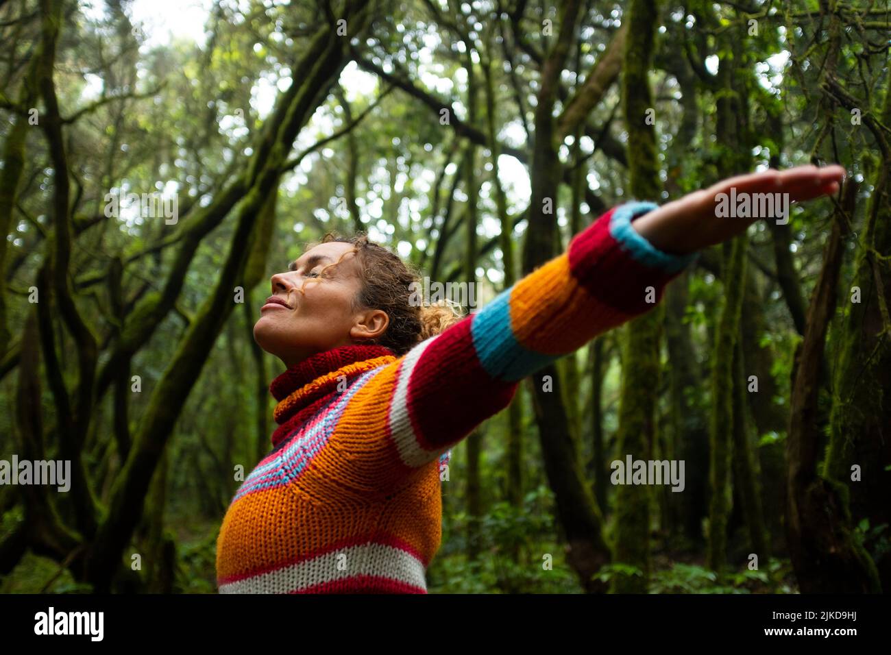 Freedom and happiness lifestyle and moment. Standing middle age young woman open arms and smile. Success life and nature feeling. Outdoors nature Stock Photo