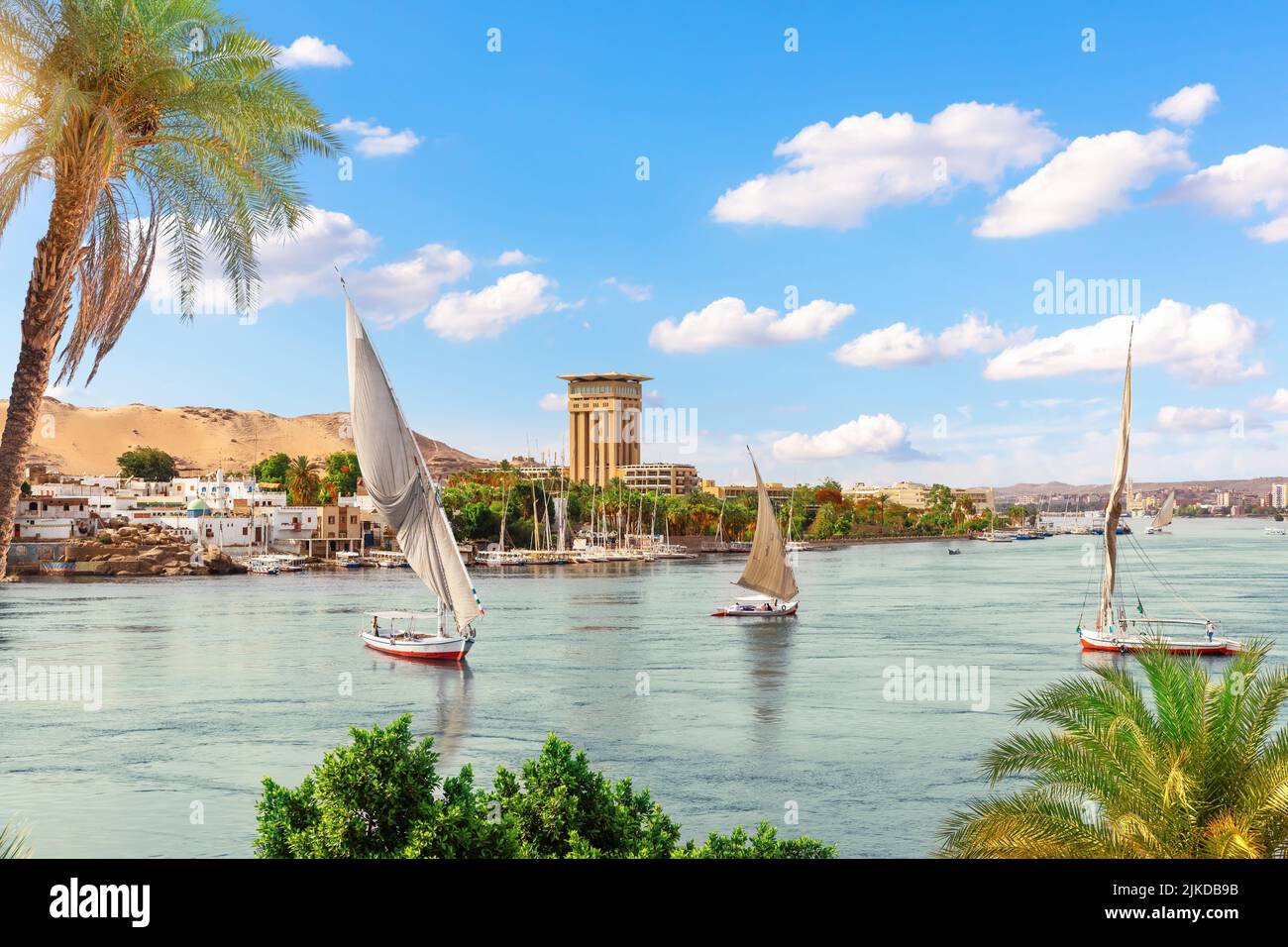 Traditional sailboats in the Nile river by the villages of Aswan, Egypt. Stock Photo