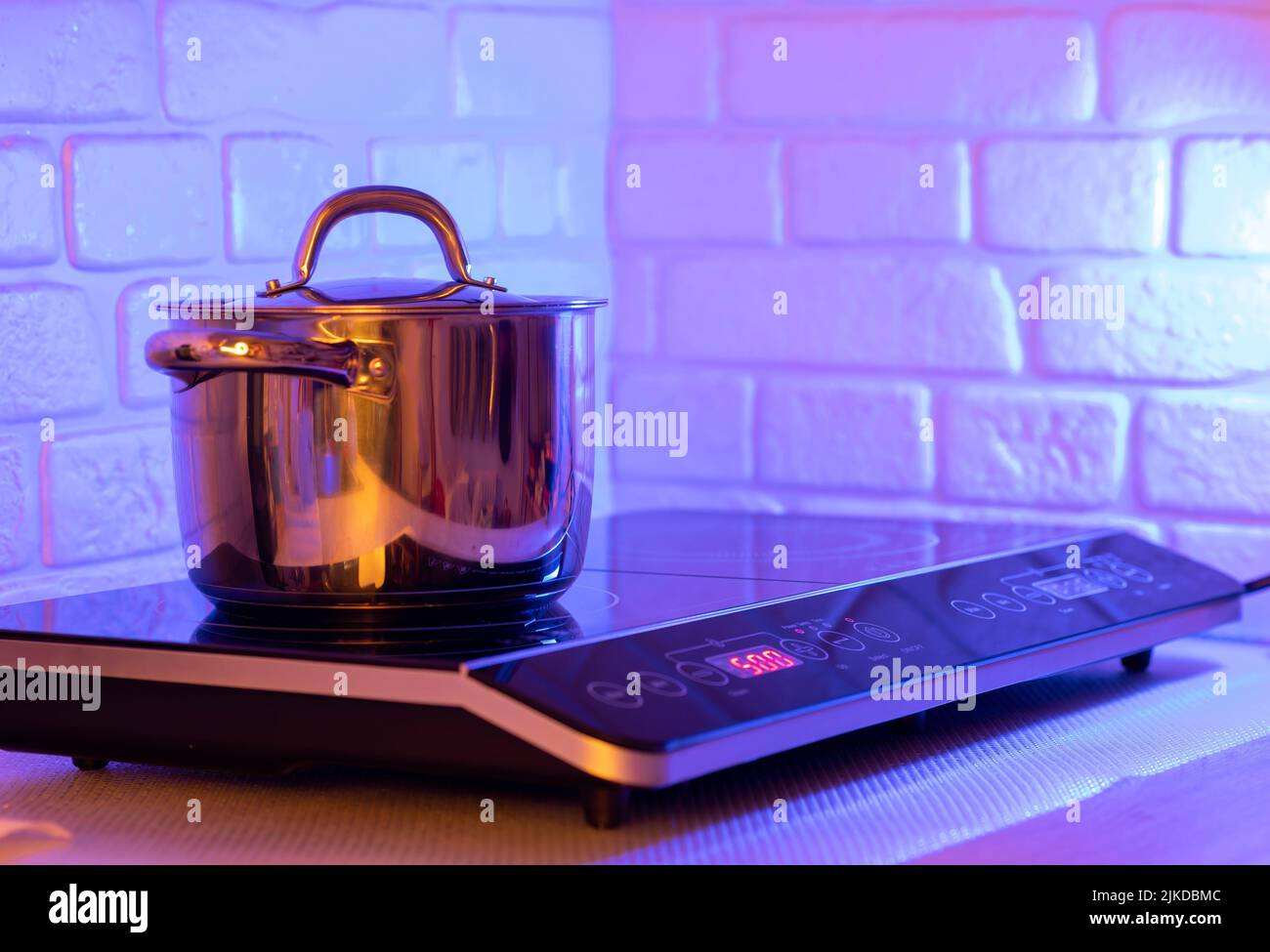 Metal Pot on induction hob in modern kitchen Stock Photo Alamy
