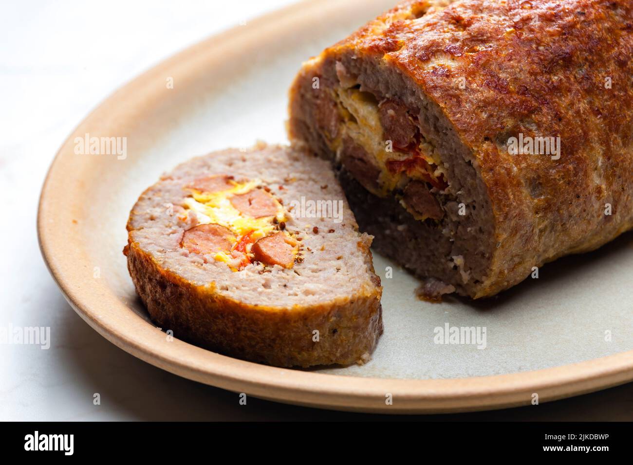 homemade meat loaf filled with egg and sausage. Stock Photo