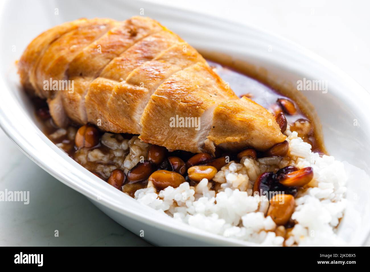 poultry breast with soya sauce and peanuts served with rice. Stock Photo