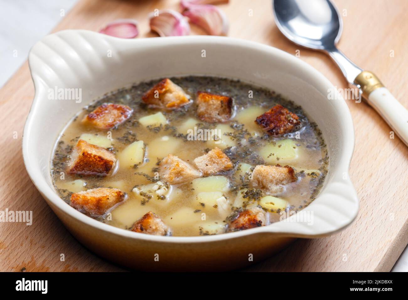 garlic soup with toasted bread and potatoes. Stock Photo