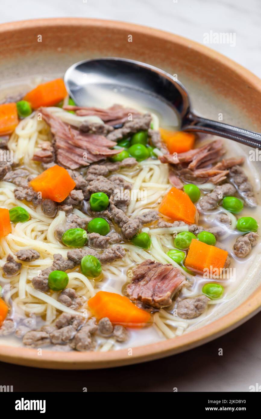 beef broth with green peas, carrot and small meatballs Stock Photo Alamy