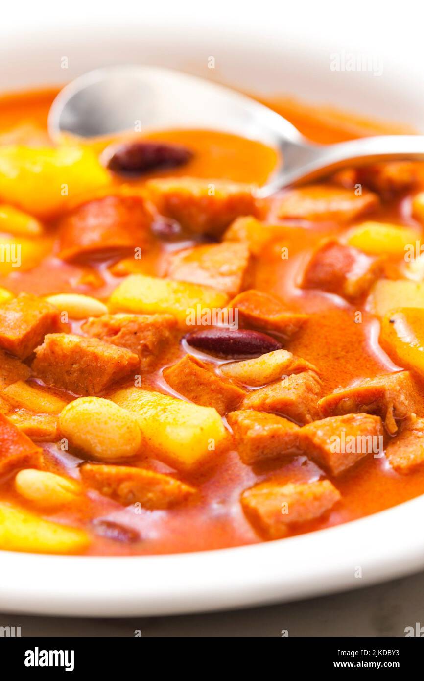 sausage goulash soup with potatoes and beans. Stock Photo