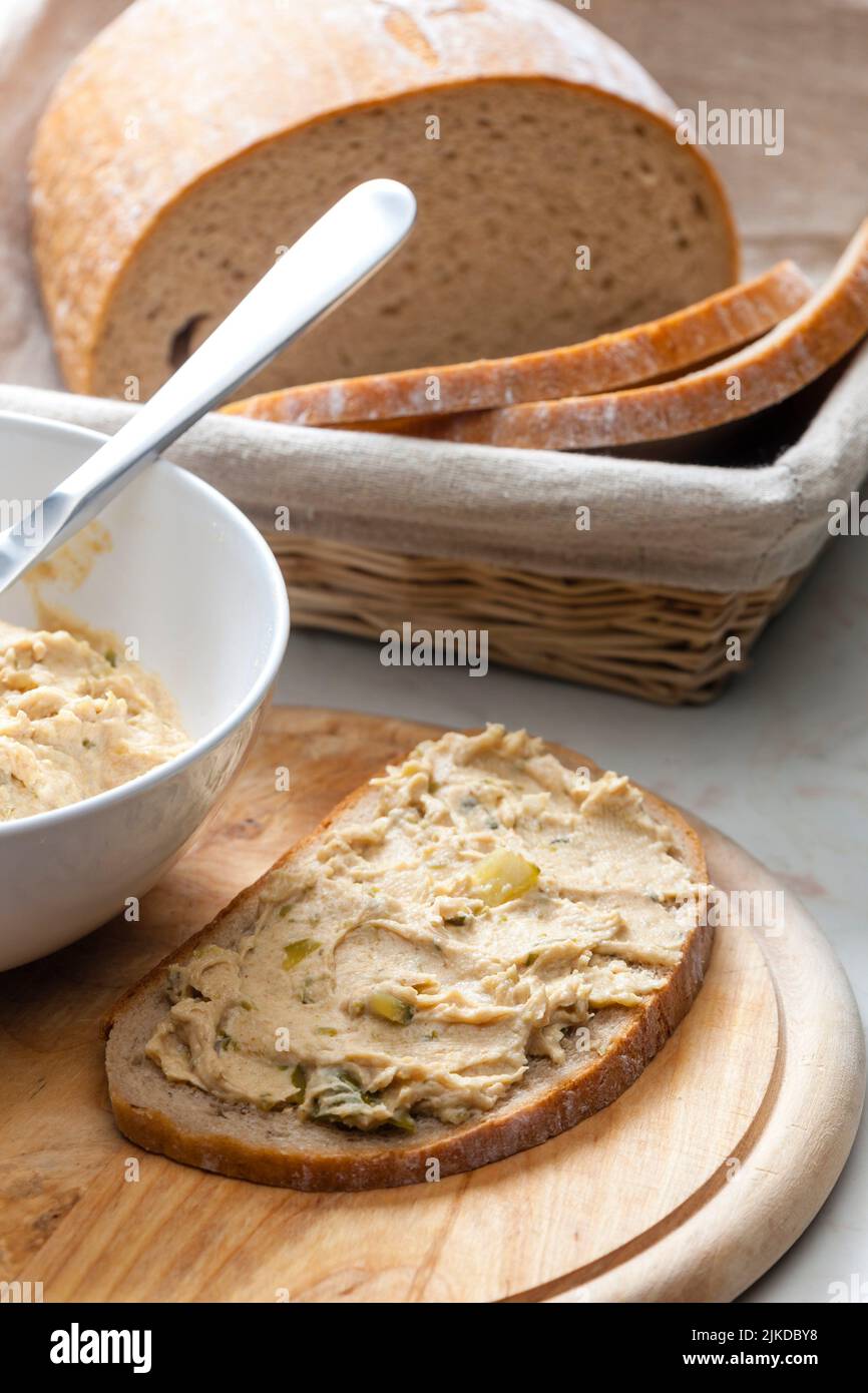 cracklings spread with pickled cucumber on slice of bread. Stock Photo