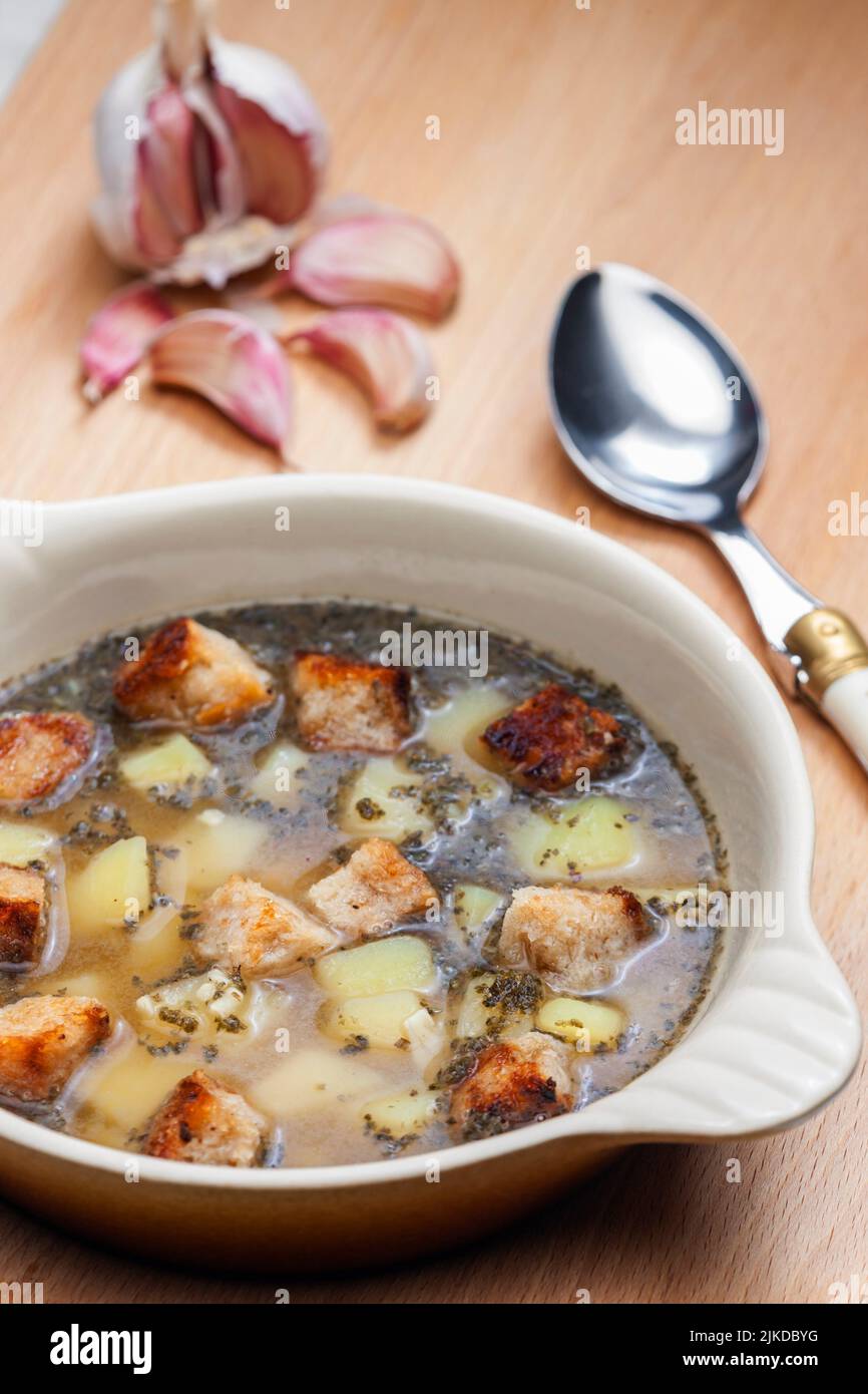 garlic soup with toasted bread and potatoes. Stock Photo