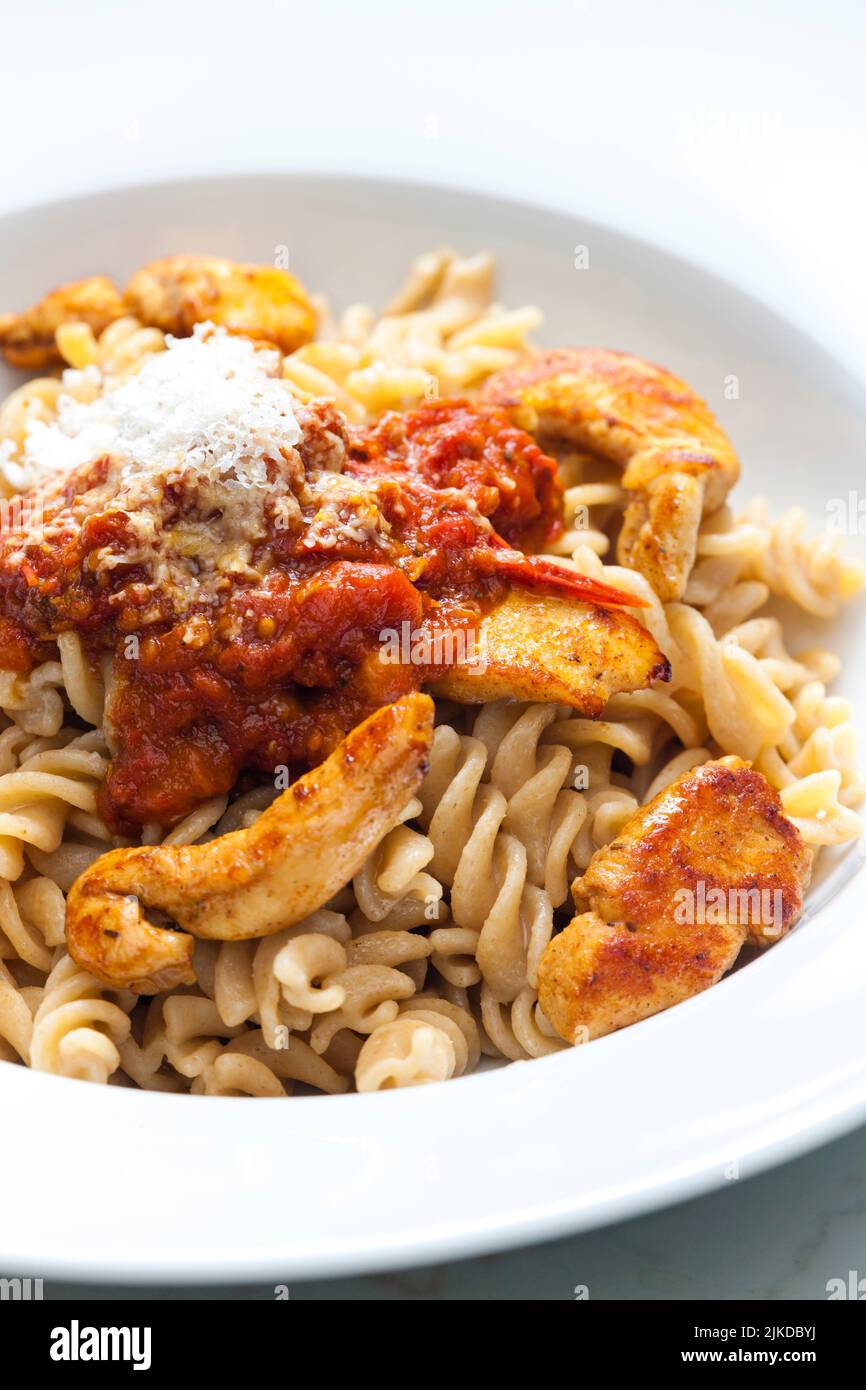 pasta fusilli with spicy chicken meat and tomato sauce. Stock Photo