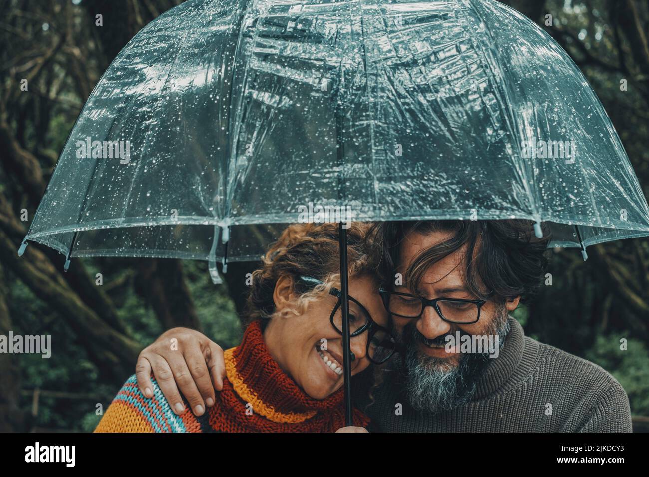 Romantic couple in love under umbrella in rainy day. Man and woman
