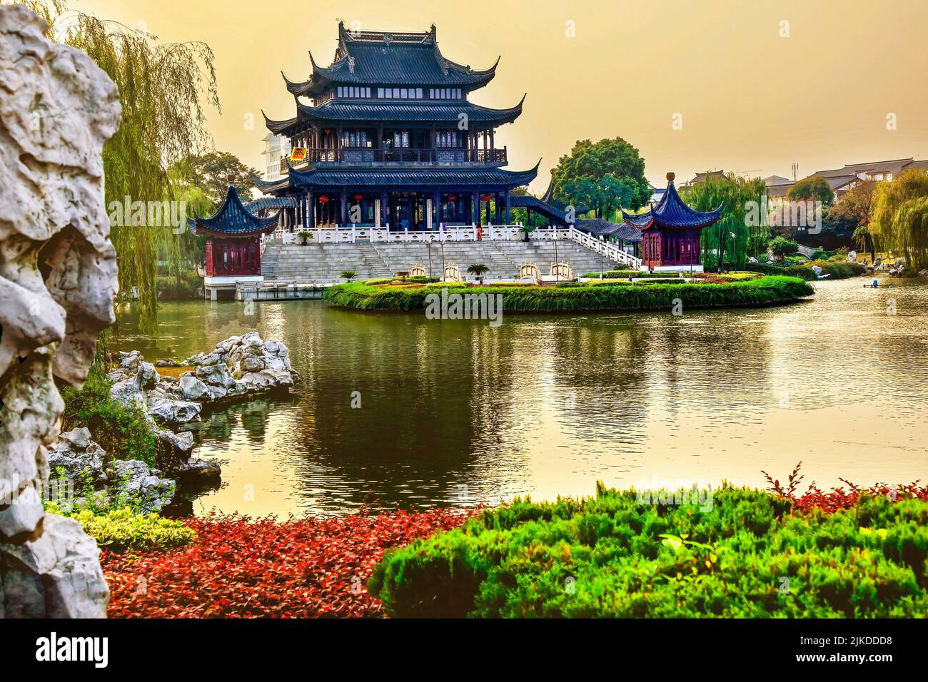 Ancient Chinese Hall of Four Auspicious Merits and Hall of Attractive Scenery Pan Men Scenic Ares Suzhou Jiangsu China Garden Lake Reflectiion.Flag Stock Photo