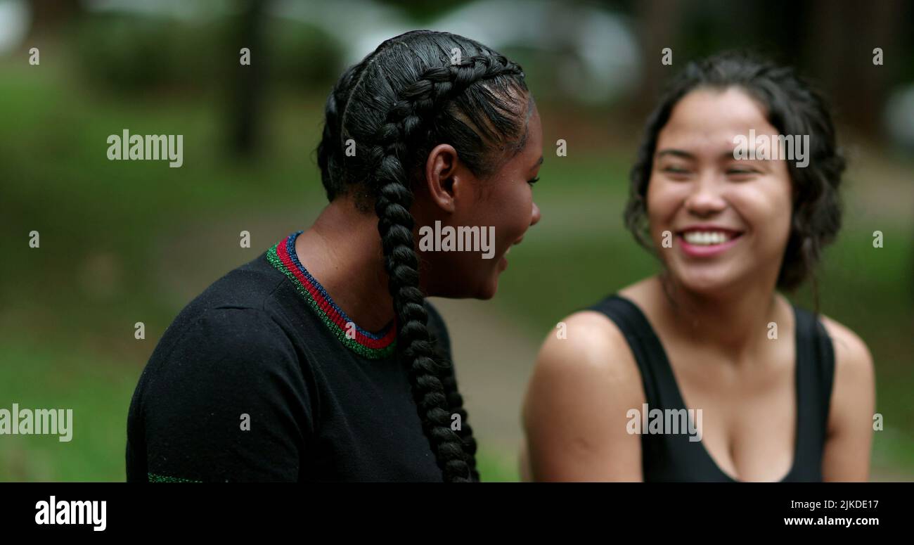 Two diverse friends laughing and smiling together. Mixed race ...