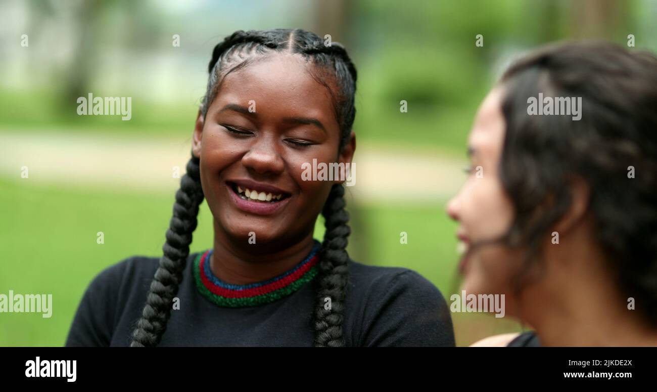 Two diverse friends laughing and smiling together. Mixed race ...