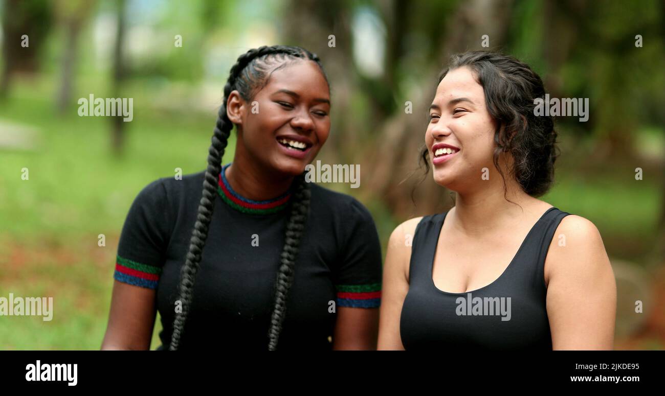Two diverse friends laughing and smiling together. Mixed race ...