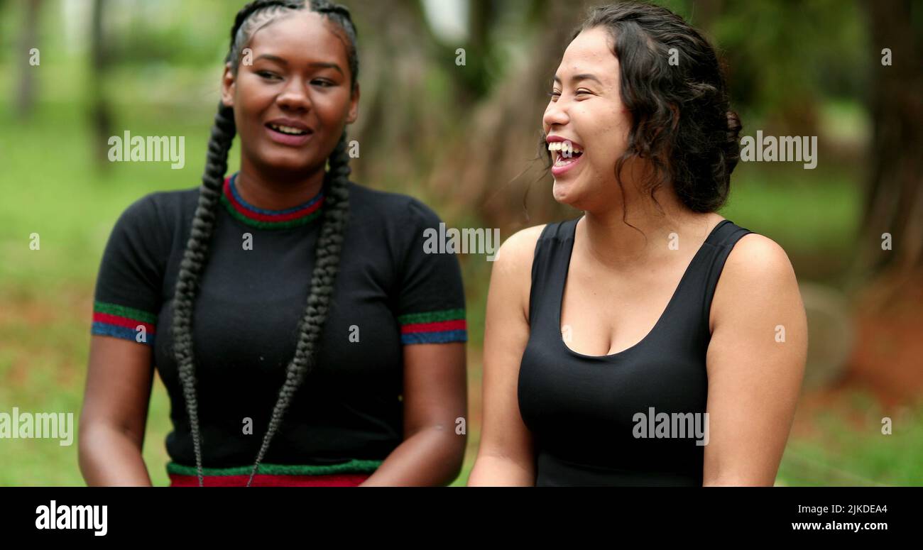 Two diverse friends laughing and smiling together. Mixed race ...