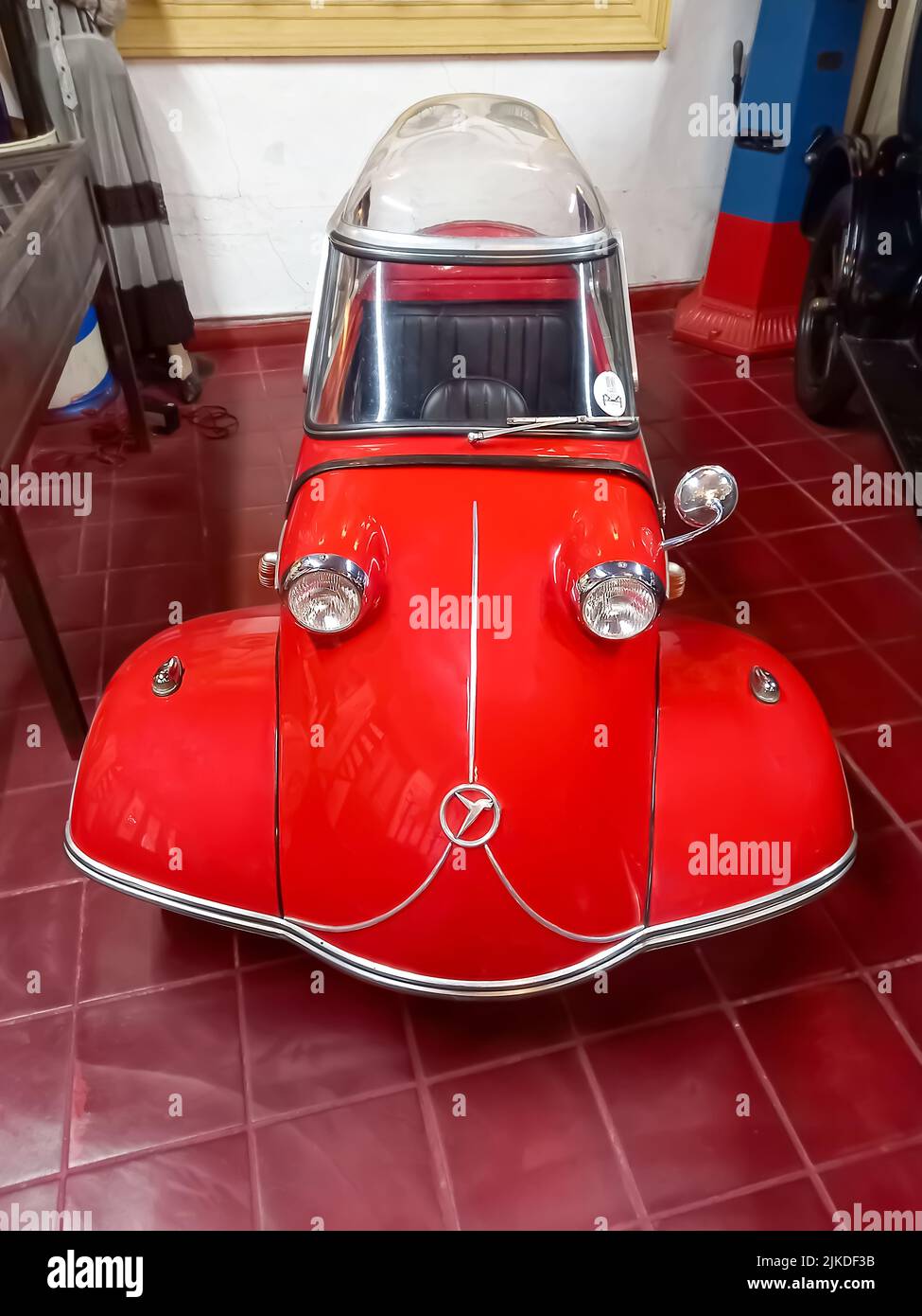 Old classic red economy Messerschmitt KR200 Kabinenroller 1959 coupe one door three wheel German micro car. Rau car Collection. Front view. High angle Stock Photo