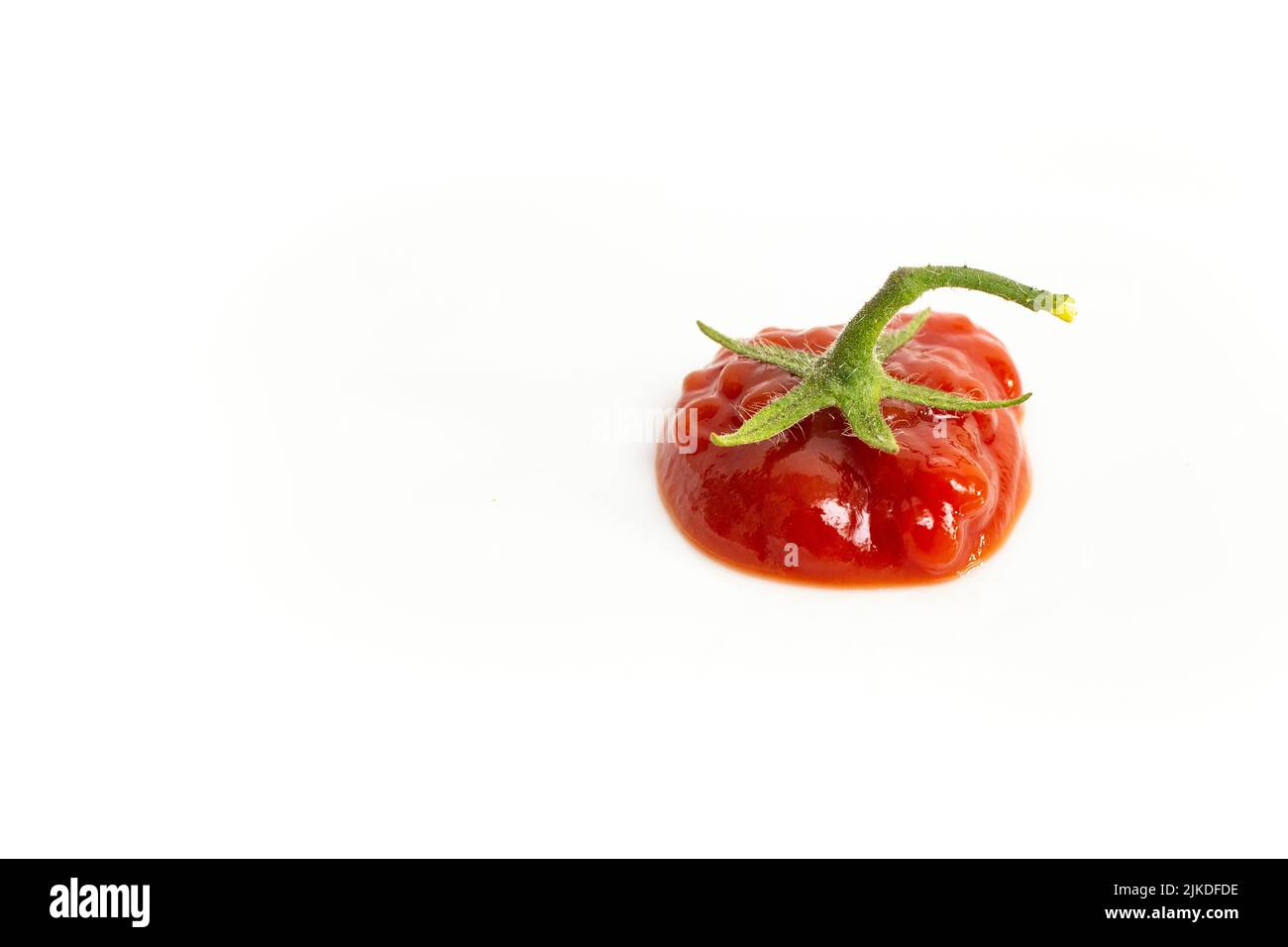 Ketchup blob with a star shaped tomato stem, isolated on white background Stock Photo