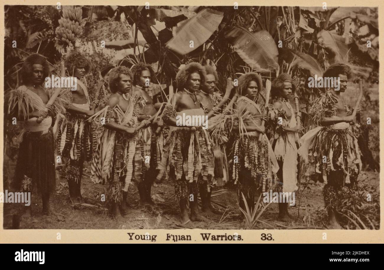 Young Fijian warriors. F. W. Caine (Publisher). Pacific pursuits : Postcards Fiji. Date Issued: 1913 (Approximate) Place: Printed in England. Stock Photo