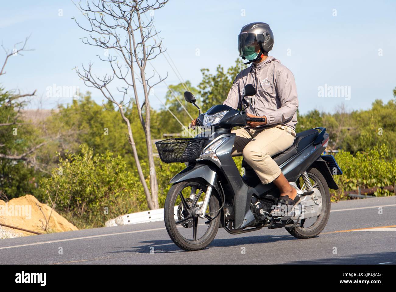 BANGKOK, THAILAND, JUNE 05 2022, A man with helmet rides a motorcycle
