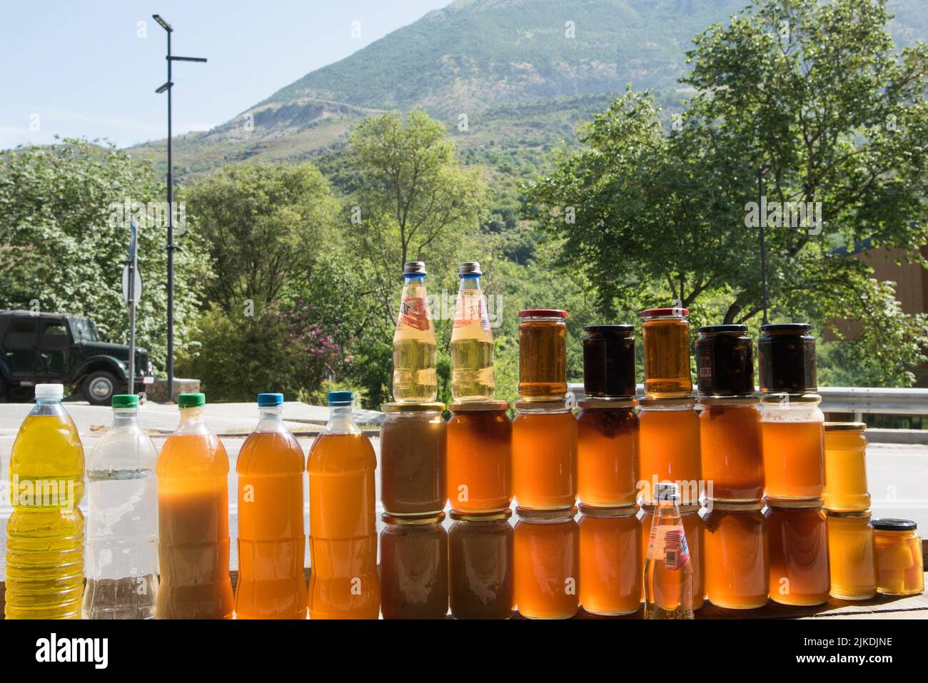 Honey pots for sale at the roadside, between Saranda and Gjirokaster, where local produce is sold,Albania, Southeastern Europe. Stock Photo