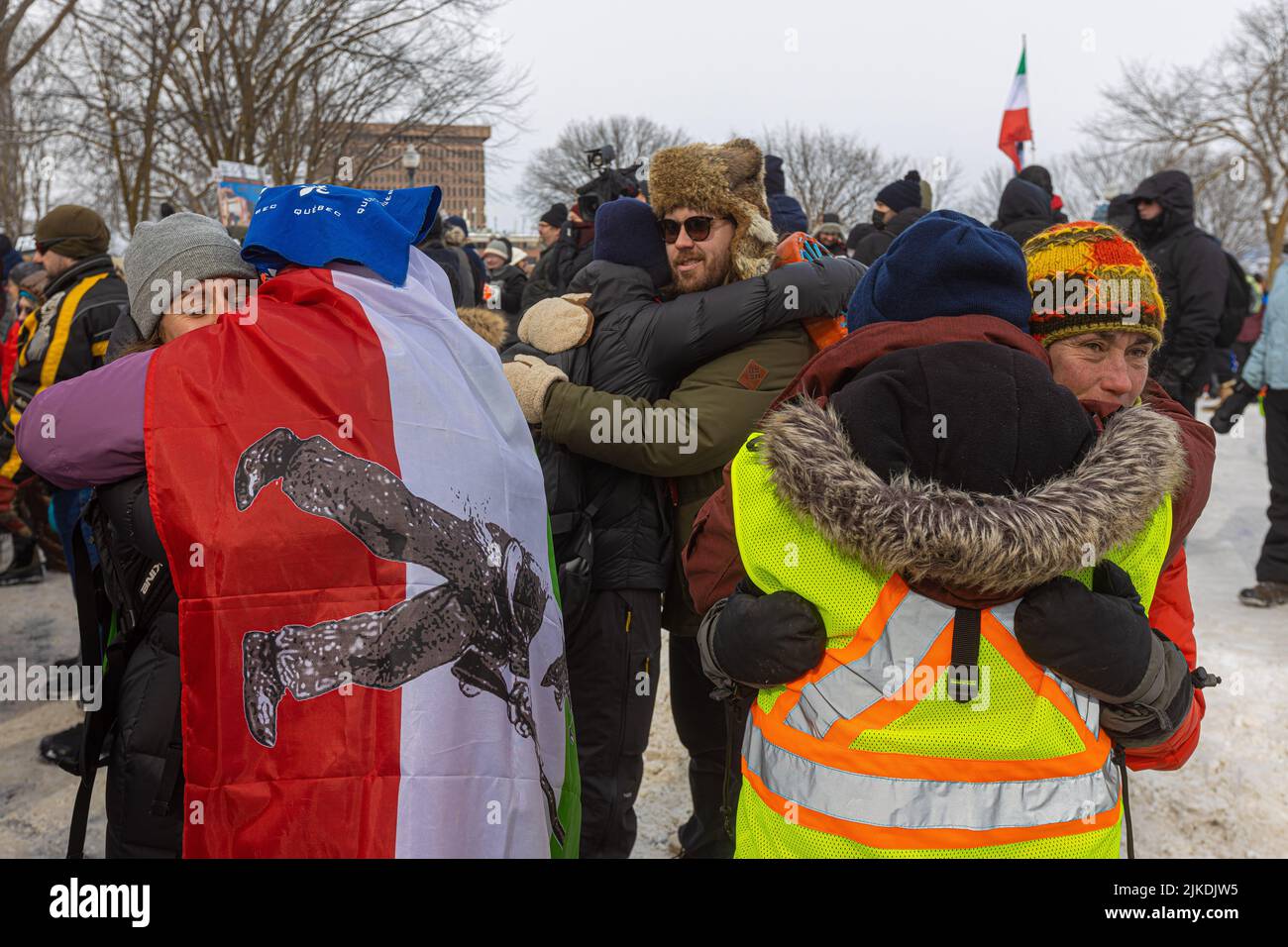 Protesters hug each others after a communal meditation during the 'convoie de la liberte' (freedom convoy) rally near the National Assembly in Quebec city Sunday February 20, 2022. Stock Photo