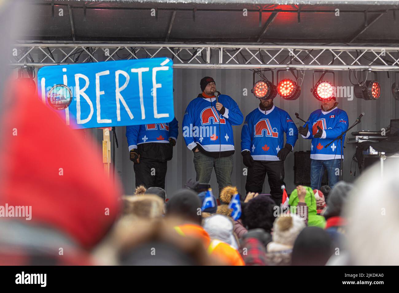 Protest organizers speak to the crowd during the 'convoie de la liberte' (freedom convoy) rally near the National Assembly in Quebec city Sunday February 20, 2022. Stock Photo