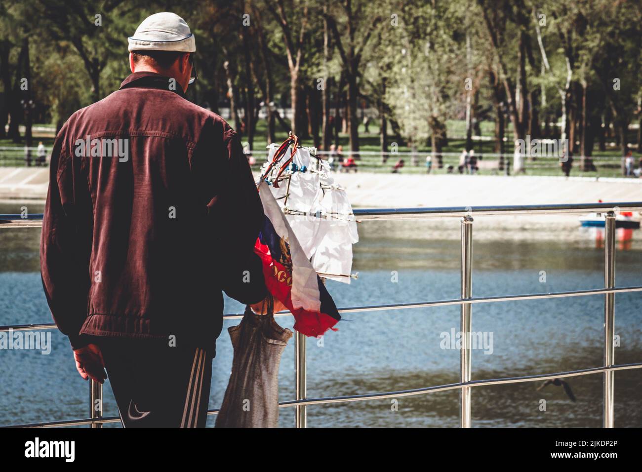 Russian warship. A man with a sailboat in his hands. Ship with Russian ...
