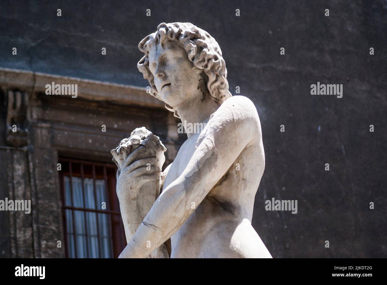 Sculpture of God Amenano, symbolizing Amenano River which flows underneath fountain. Amenano Fountain, Piazza Duomo, Metropolitan City of Catania, Stock Photo