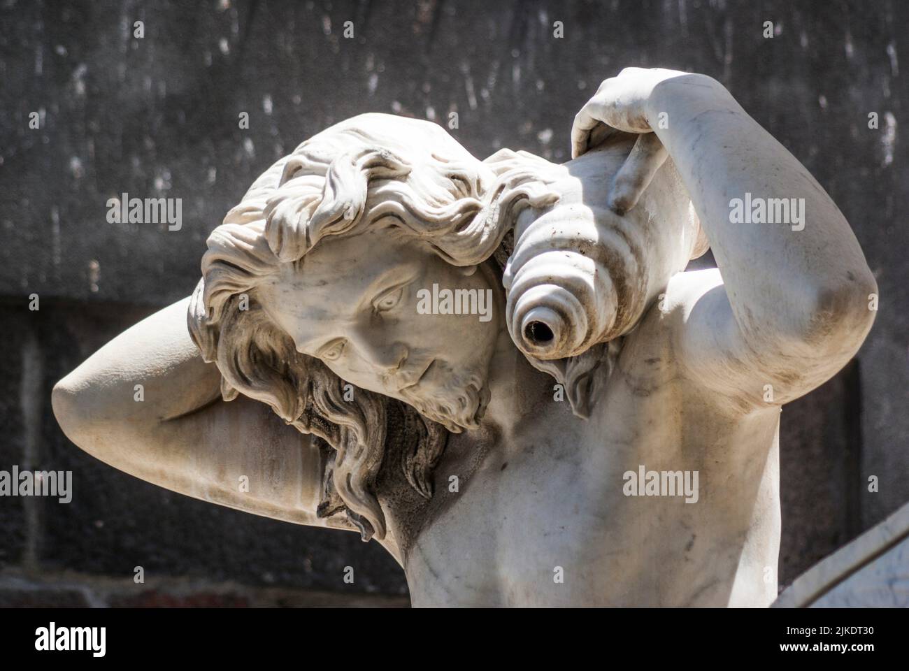 Detail, one of two fountain tritons. Amenano Fountain, Piazza Duomo, Metropolitan City of Catania, Sicily, Italy. Stock Photo