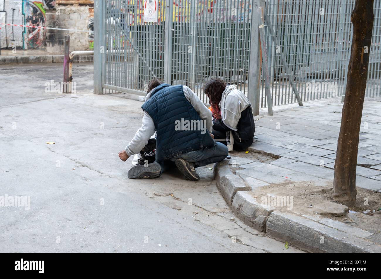 ATHENS, GREECE - MAY 14, 2022: A homeless man sleeps on a sidewalk in ...
