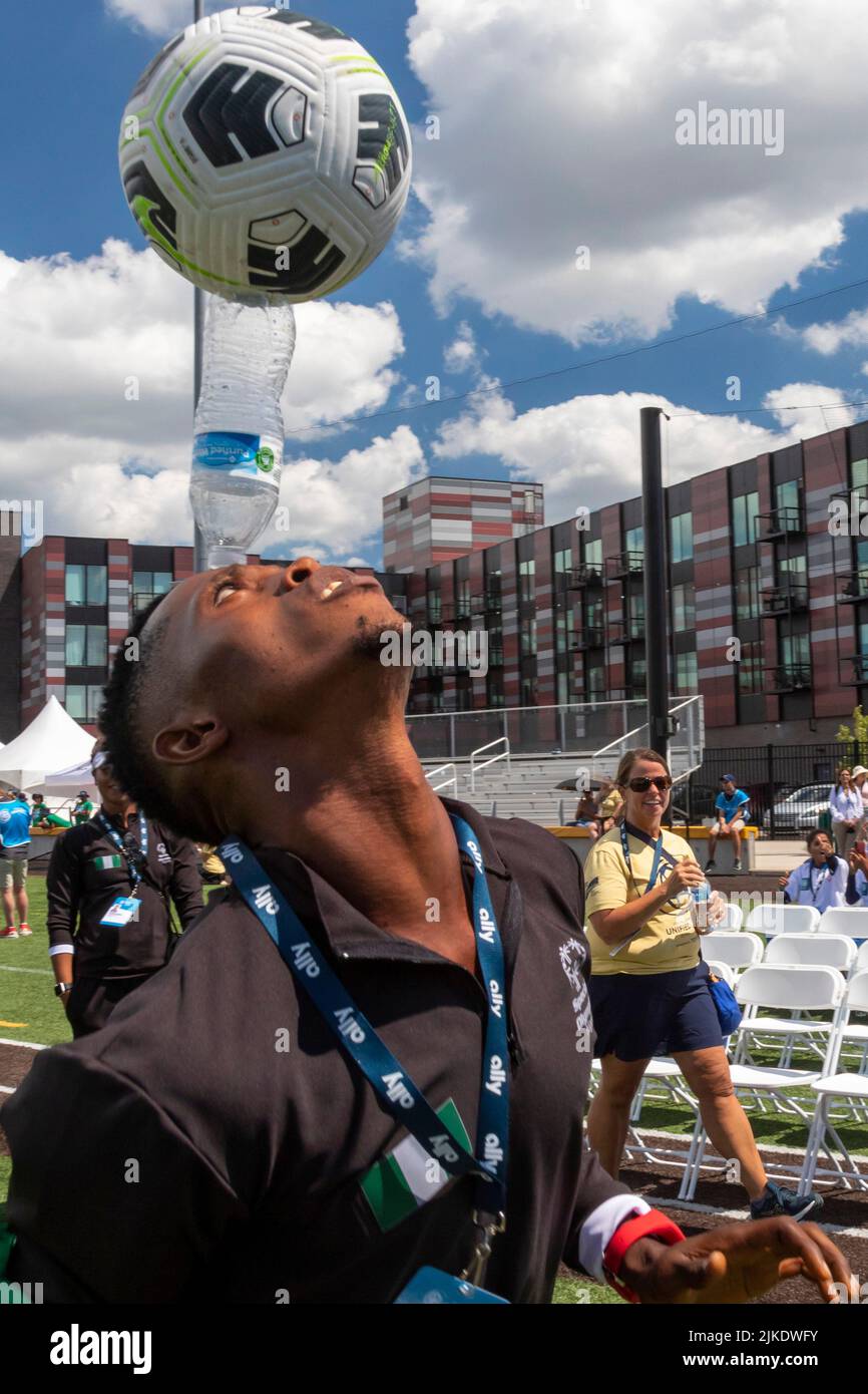 Detroit, Michigan, USA. 31st July, 2022. The Special Olympics Unified Cup football (soccer) tournament. Aliu Ali of the Nigerian men's team balances a water bottle and soccer ball on his head during the opening ceremonies. The Unified Cup pairs athletes with and without intellectual disabilities as teammates. Credit: Jim West/Alamy Live News Stock Photo