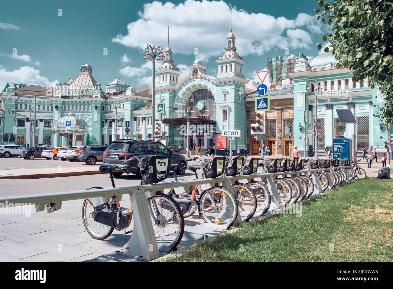 A row of parked rental bikes on Tverskaya Zastava Square in front of Belorussky Railway Station: Moscow, Russia - July 22, 2022 Stock Photo