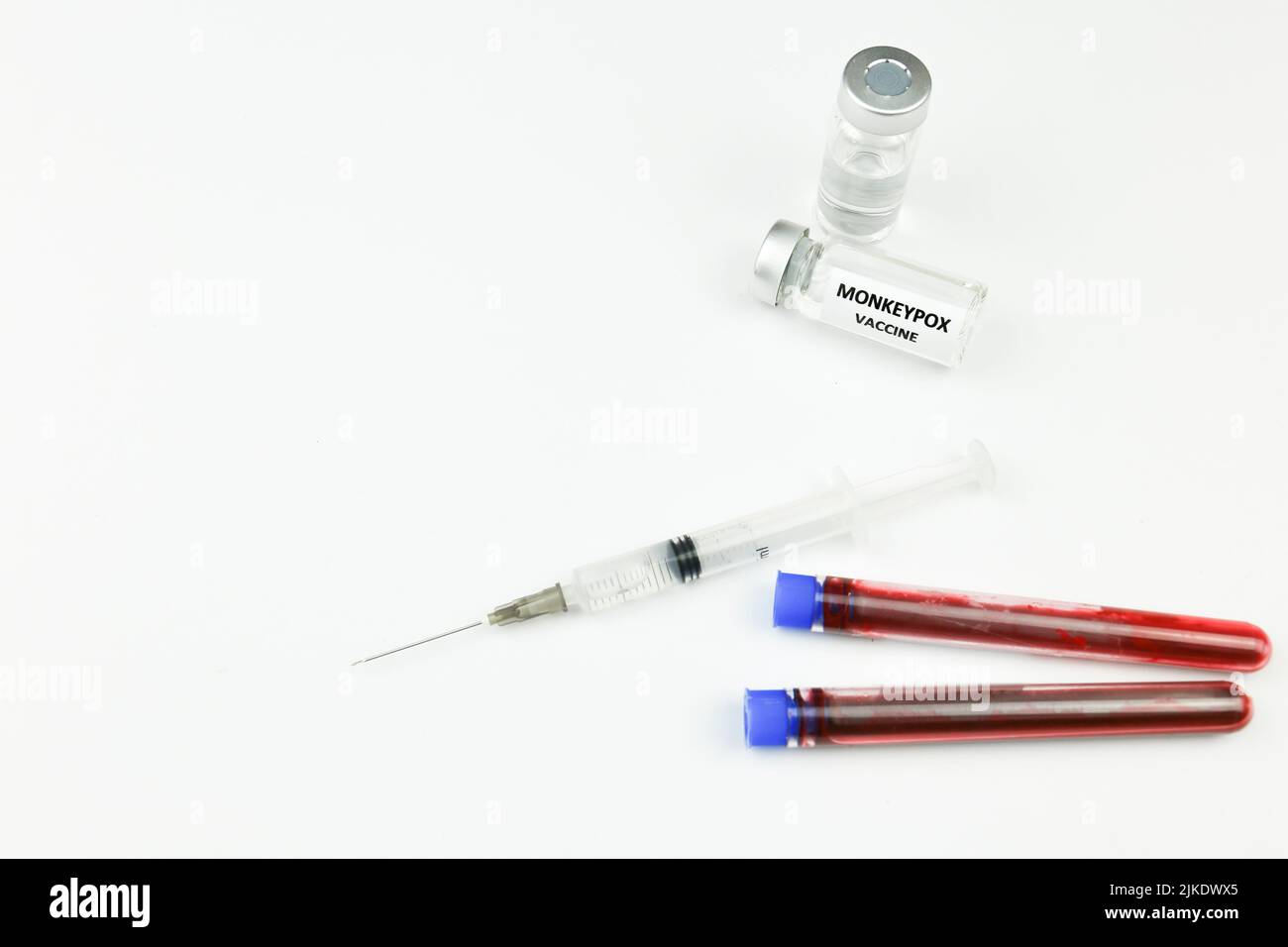 Syringe and vials filled with Monkeypox vaccine next to test tubes with ...