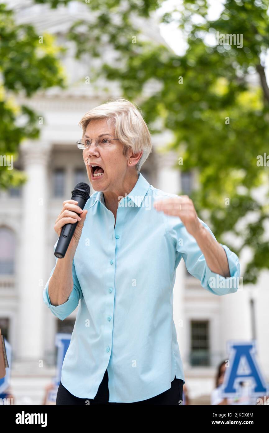 Democratic Senator Elizabeth Warren holds a microphone and speaks at an outdoor event Stock Photo