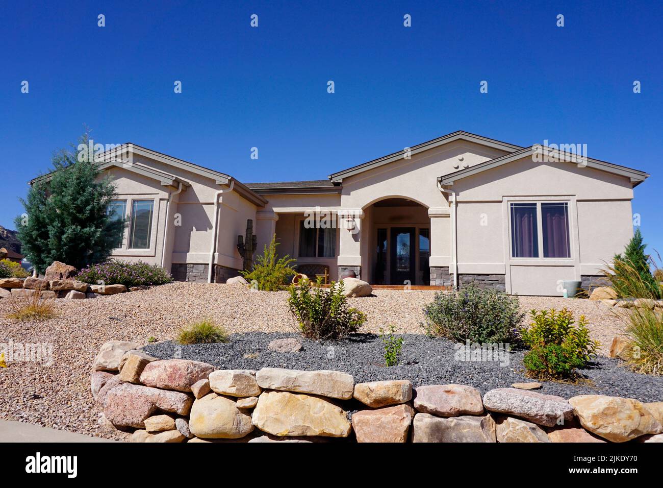 Modern stucco house with drought tolerant landscaping Stock Photo