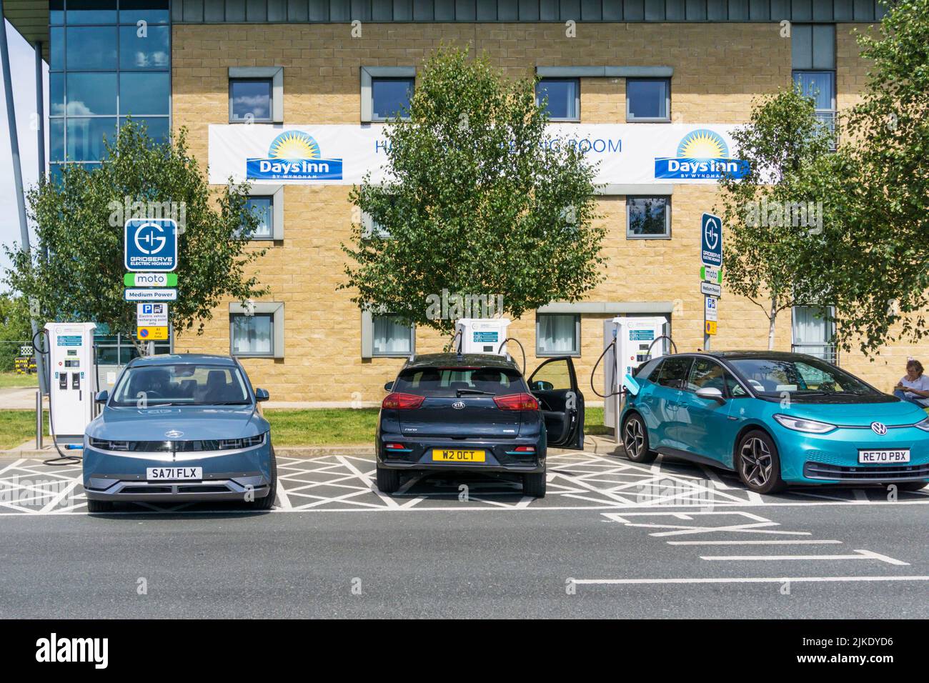 Electric vehicles charging at charging stations outside a Days Inn hotel at the Wetherby services on the A1(M) motorway. Stock Photo