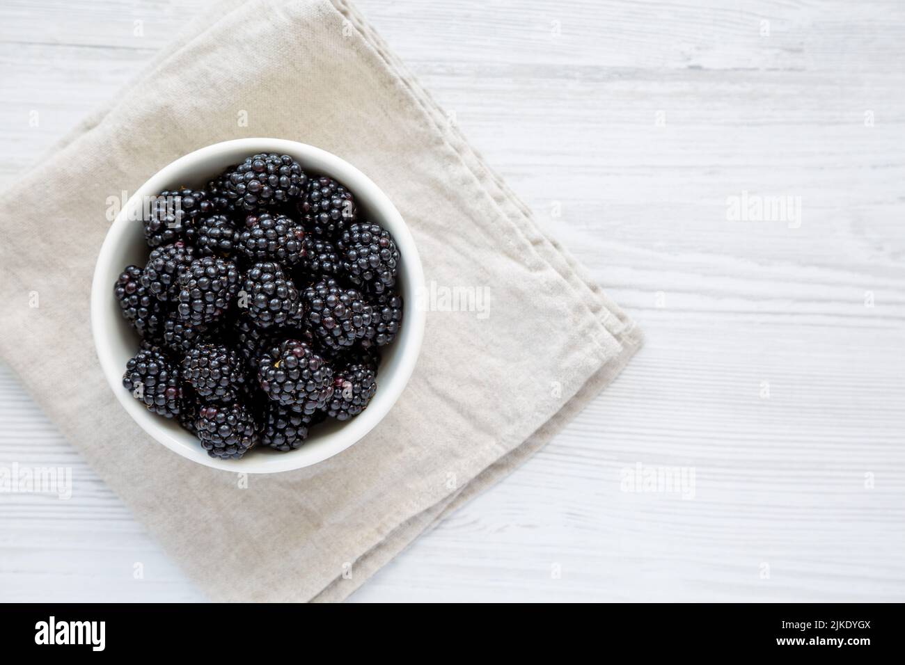 Raw Blackberries in a Bowl, top view. Flat lay, overhead, from above. Copy space. Stock Photo