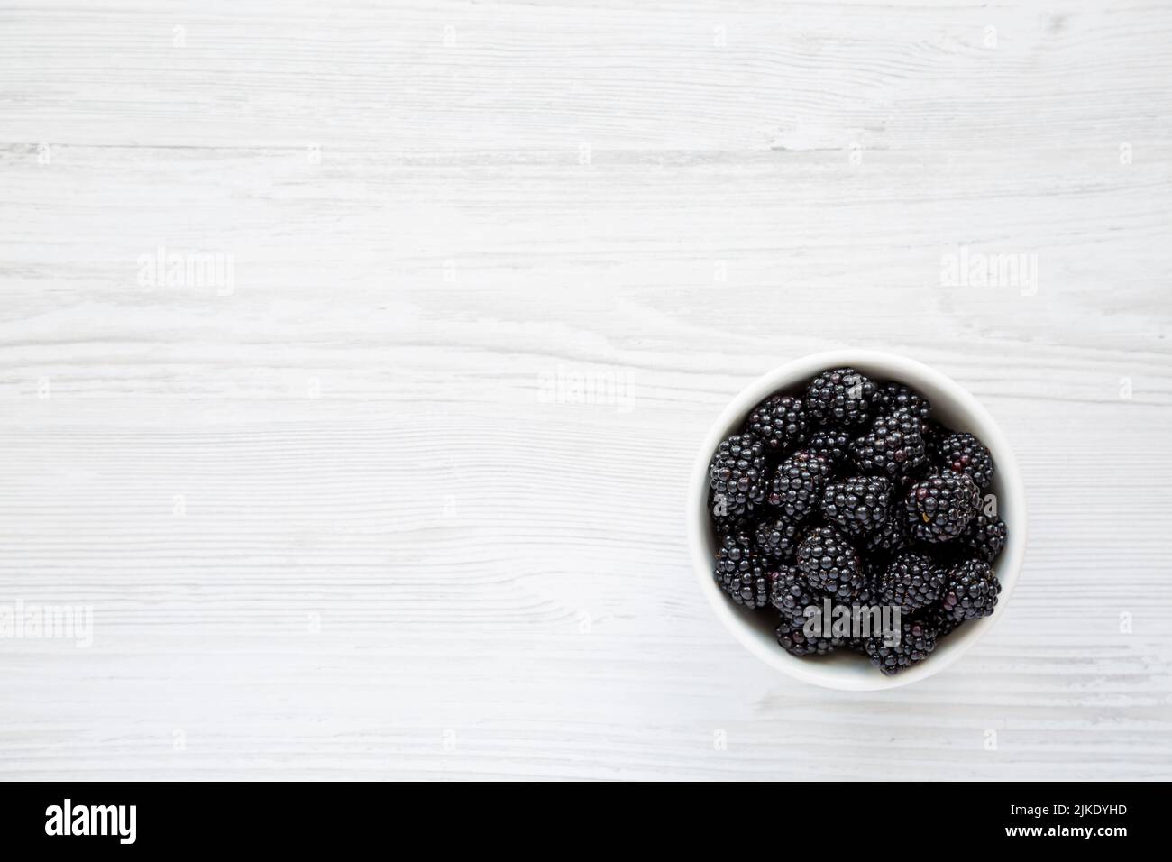 Raw Blackberries in a Bowl, top view. Flat lay, overhead, from above. Copy space. Stock Photo