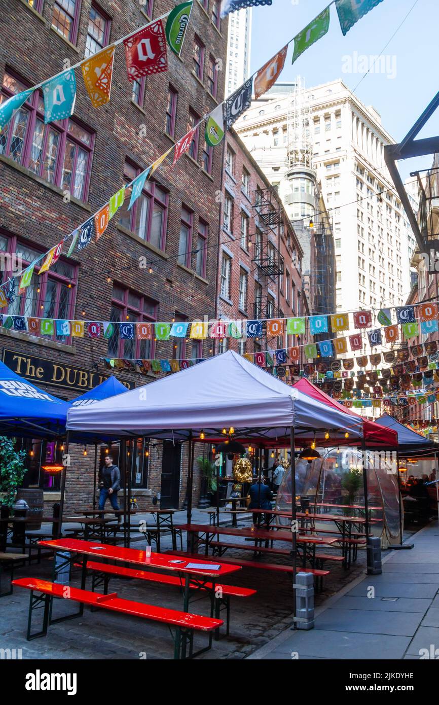 New York City, NY, USA April 29 2022: Stone Street is a popular pedestrian zone in Lower Manhattan Financial District. There are many bars and restaur Stock Photo