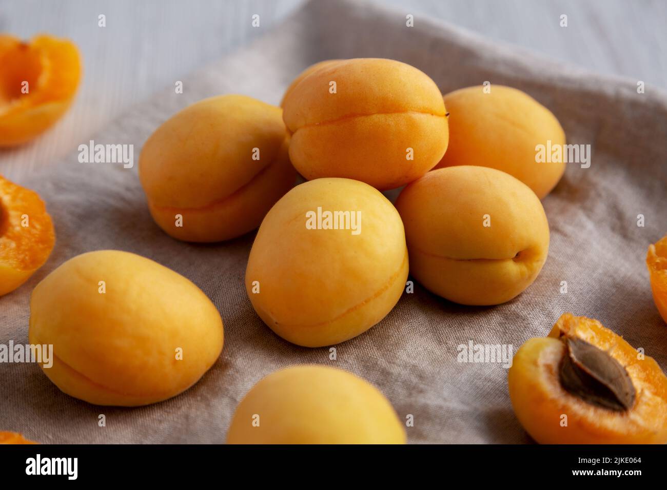 Raw White Apricot Angelcots on a white wooden surface, side view. Stock Photo