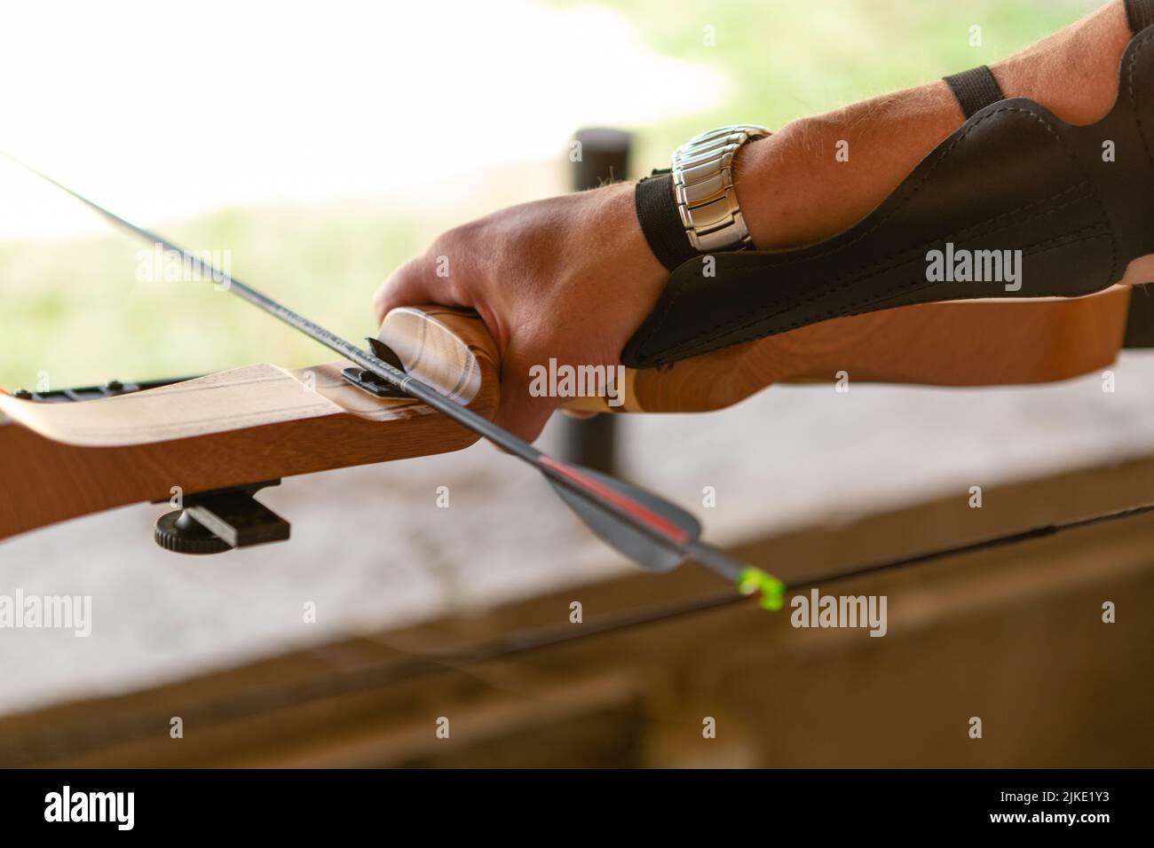 Hand holding a bow and arrow Stock Photo