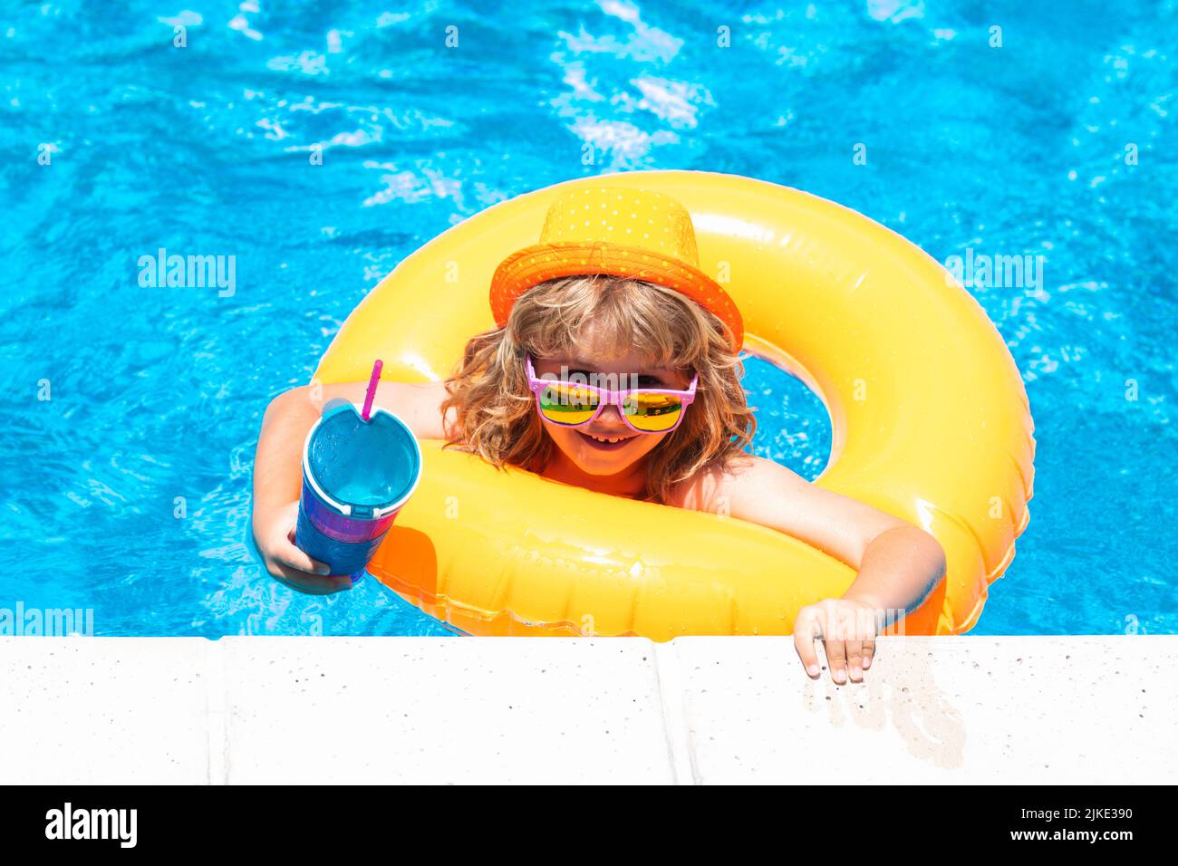 Boy swimming and playing in a pool. Child playing in swim pool. Summer