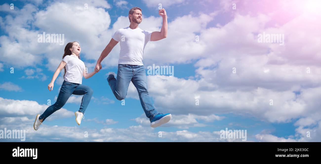 Father and daughter jump on sky, banner with copy space. happy father ...