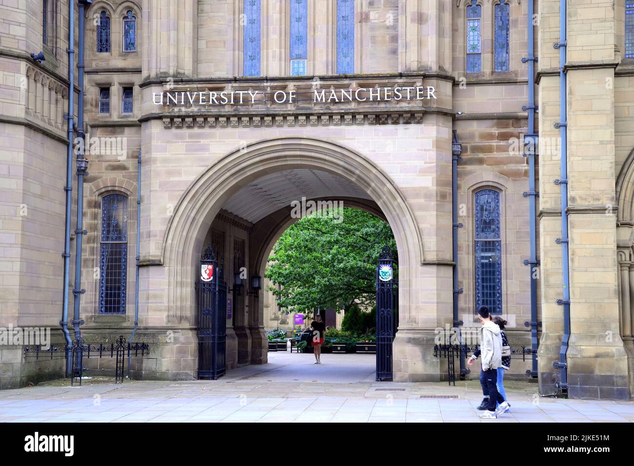 People walk in front of Whitworth Hall, University of Manchester, Oxford Road, Manchester, England, United Kingdom, British Isles. The UK Government has stopped the University of Manchester from licensing vision sensing technology to a Chinese company, citing national security grounds. The UK Government believes there is “potential” for this technology to be used for military purposes and can use the National Security and Investment Act 2021 to halt the agreement. The University of Manchester had made an agreement with Beijing Infinite Vision Technology Company Ltd. Stock Photo