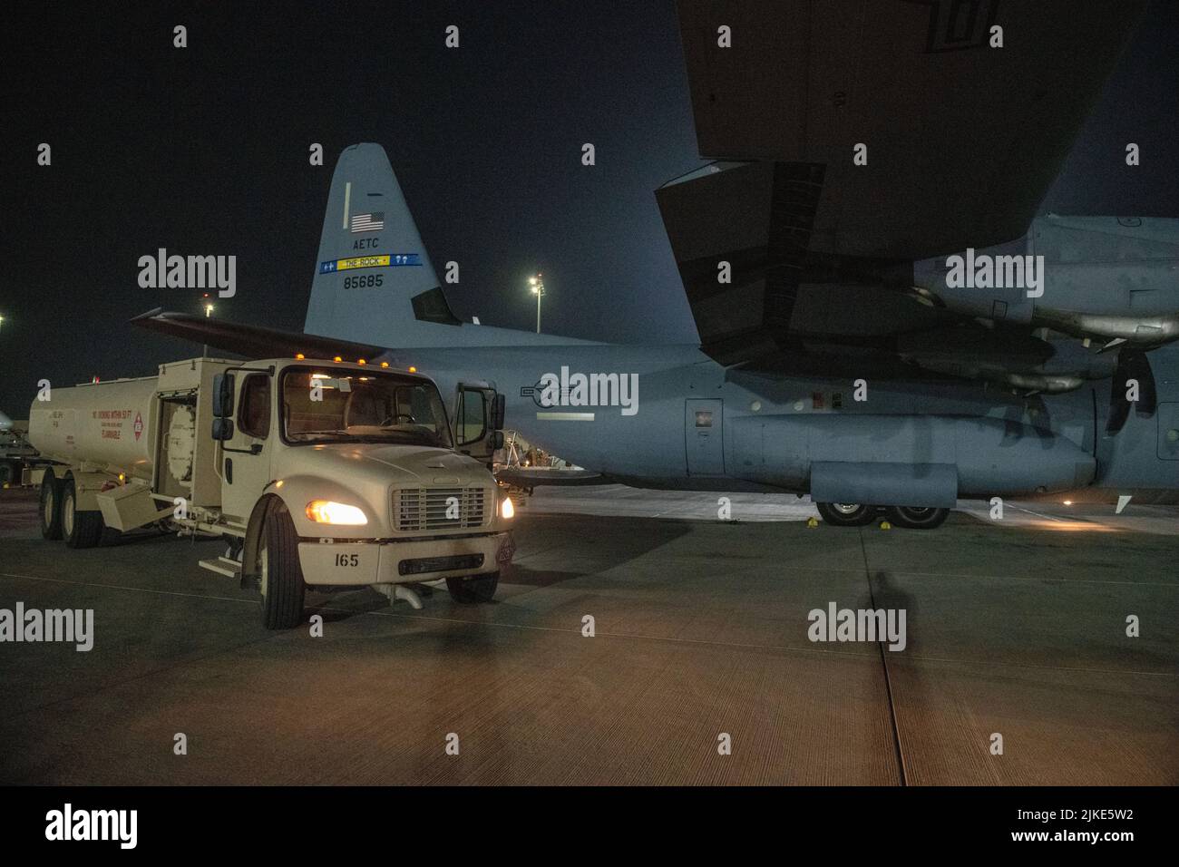 A fuel truck belonging to the U.S. Air Force 379th Expeditionary Logistics Readiness Squadron sits next to a C-130 prior to refueling on Al Udeid Air Base, Qatar, July 18, 2022. Different aircraft require different types of fuel.  (U.S. Air National Guard photo by Airman 1st Class Constantine Bambakidis) Stock Photo