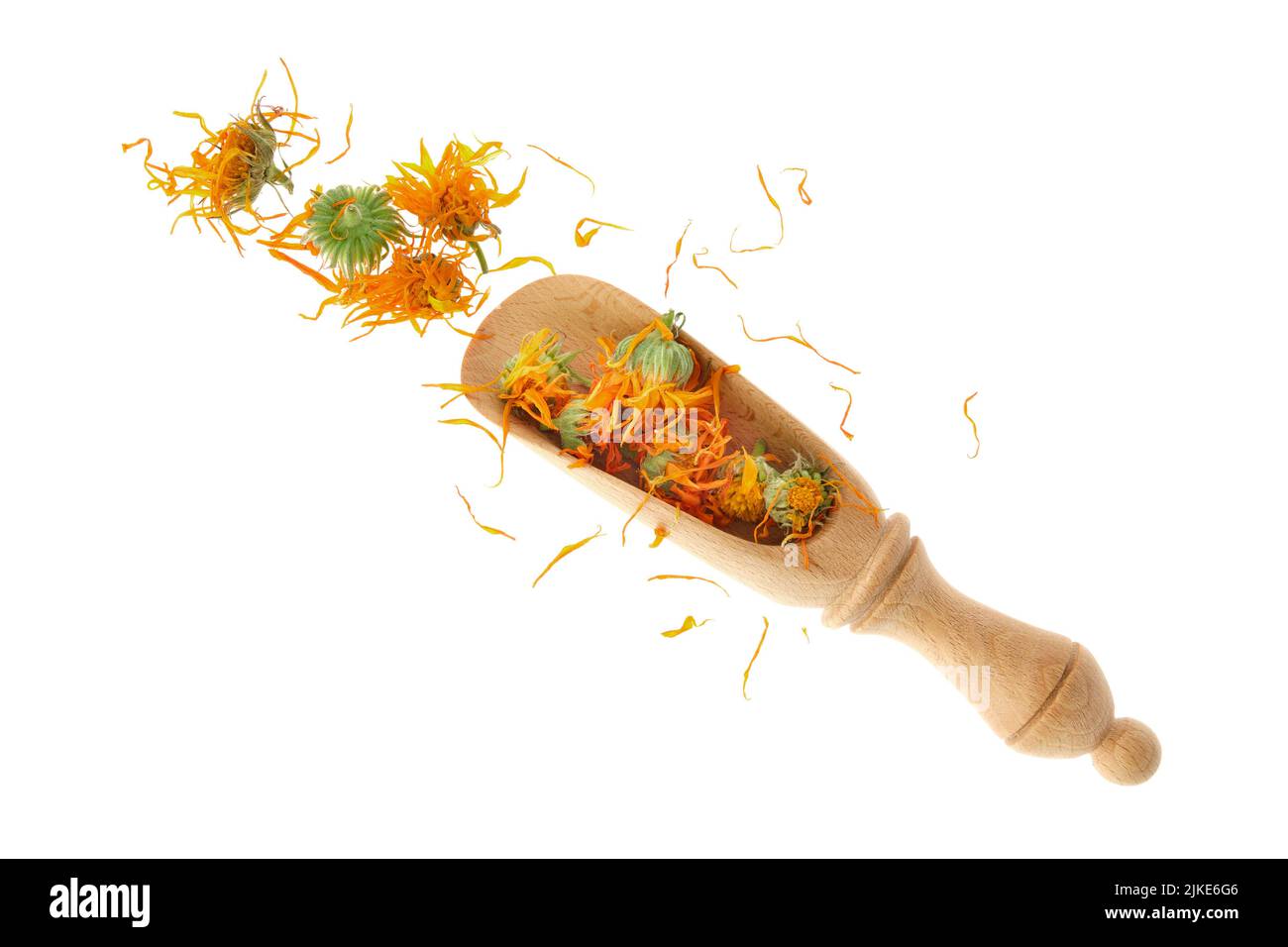 Wooden scoop of dried calendula flowers, isolated on white background. Petals of calendula flowers for making healthy herbal tea. Top view. Stock Photo
