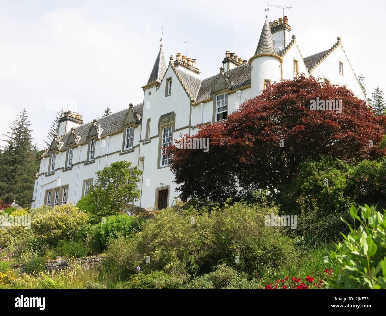 Logie House, a white harled family home in the Scots Baronial style, was originally built in the 17th century, bought in 1924 by Sir Alexander Grant. Stock Photo