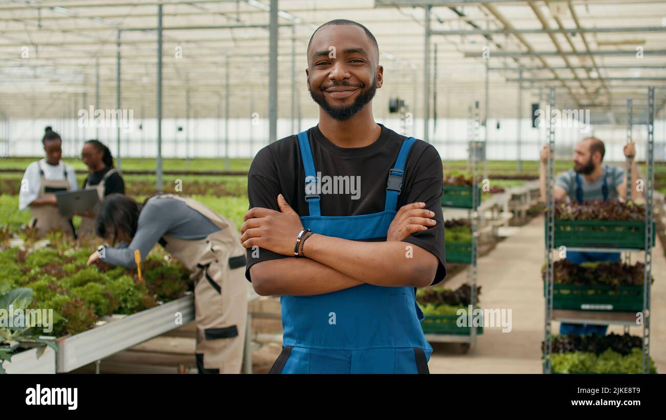 Portrait of african american farmer posing with arms crossed in modern ...