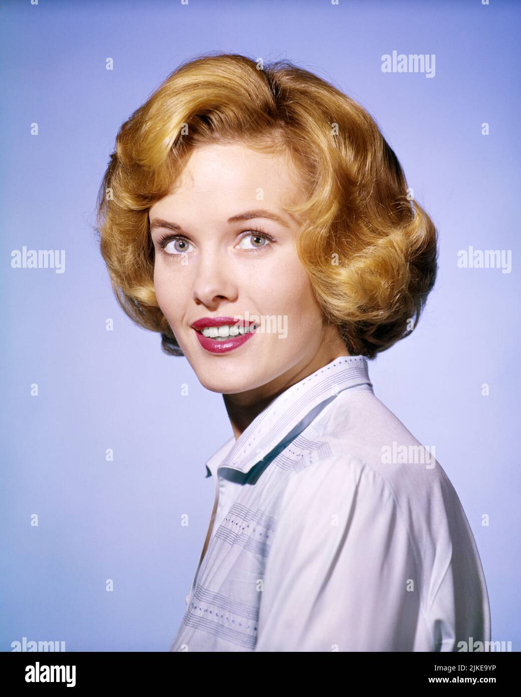 1960s SMILING WOMAN PORTRAIT LOOKING AT CAMERA IN WHITE BLOUSE GOLDEN HAIR RED LIPSTICK  - kg1467 DEB001 HARS EXPRESSIONS EYE CONTACT HAPPINESS HEAD AND SHOULDERS CHEERFUL HAIRSTYLE LIPSTICK BLOUSE SMILES CONNECTION WAVY GREEN EYES JOYFUL STYLISH WHITE BLOUSE DEB001 PLEASANT TEASED YOUNG ADULT WOMAN BOUFFANT DIRECT OLD FASHIONED Stock Photo