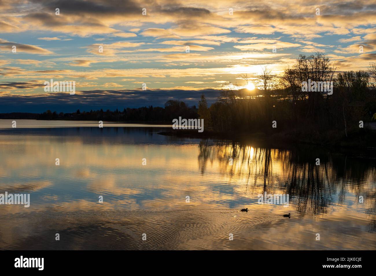 Osisko Lake on sunset time. Beautiful reflection like a mirror. Landscape of Rouyn-Noranda, Abitibi-Temiscamingue, Quebec, Canada. Stock Photo